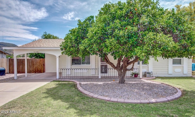 obstructed view of property featuring a front lawn and a carport