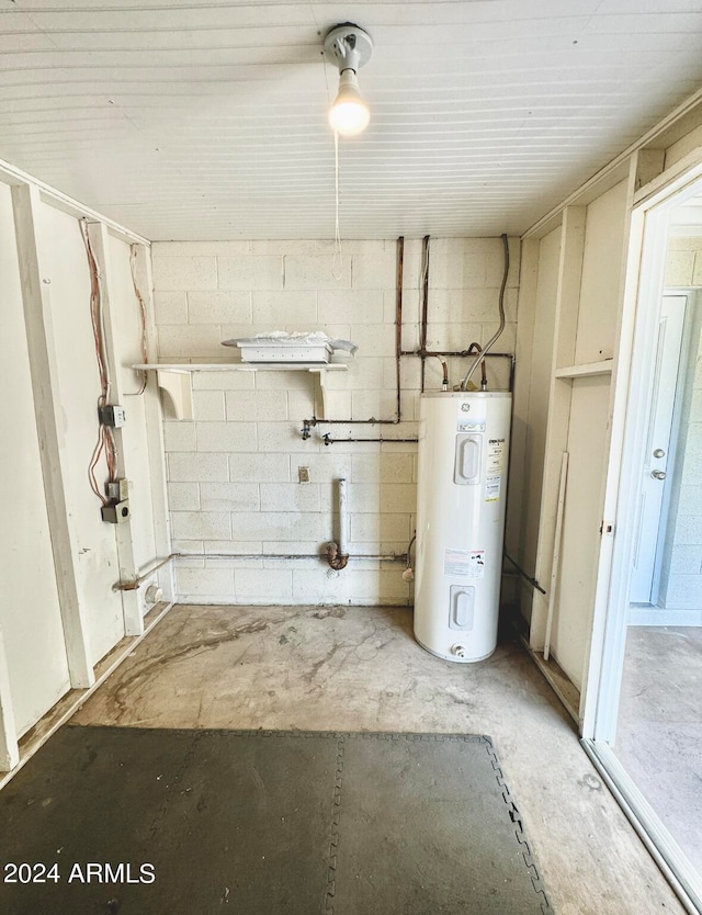 utility room featuring water heater