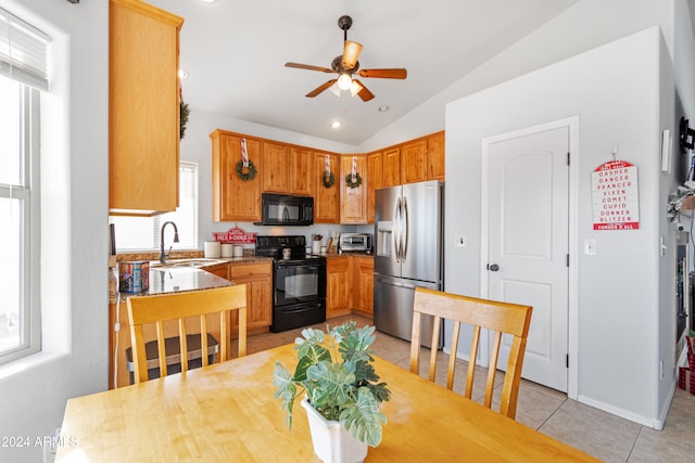 kitchen featuring ceiling fan, sink, lofted ceiling, light tile patterned floors, and black appliances