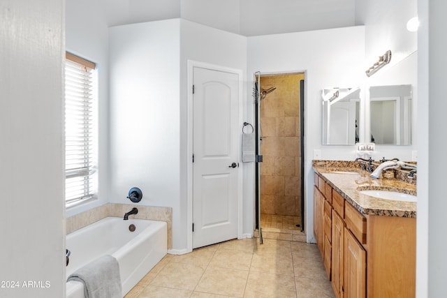 bathroom featuring tile patterned floors, vanity, a healthy amount of sunlight, and plus walk in shower