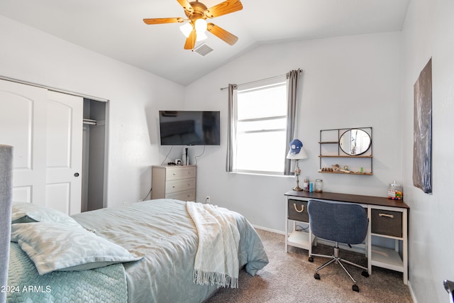 carpeted bedroom with ceiling fan, lofted ceiling, and a closet