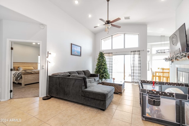 living room featuring ceiling fan, light tile patterned floors, and high vaulted ceiling