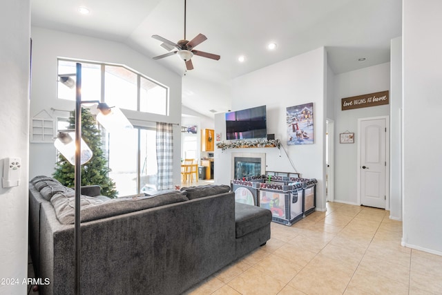 living room with ceiling fan, light tile patterned floors, and high vaulted ceiling