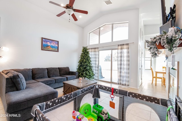 tiled living room featuring high vaulted ceiling and ceiling fan