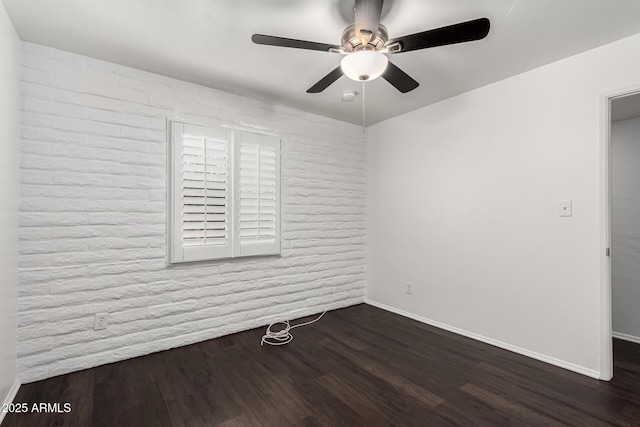3046 N 32nd St Unit 328, Phoenix, AZ 85018 - spare room with a ceiling fan, dark wood-style flooring, brick wall, and baseboards