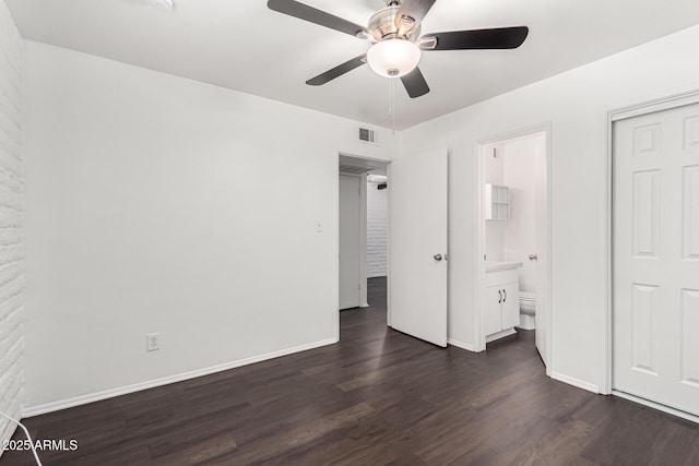 3046 N 32nd St Unit 328, Phoenix, AZ 85018 - unfurnished bedroom with dark wood-type flooring, baseboards, ensuite bathroom, and ceiling fan