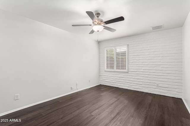 3046 N 32nd St Unit 328, Phoenix, AZ 85018 - empty room with baseboards, brick wall, visible vents, dark wood-style flooring, and ceiling fan