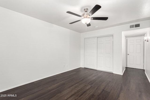 3046 N 32nd St Unit 328, Phoenix, AZ 85018 - unfurnished bedroom featuring visible vents, dark wood-type flooring, baseboards, a closet, and a ceiling fan