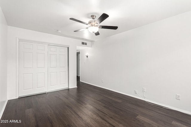 3046 N 32nd St Unit 328, Phoenix, AZ 85018 - unfurnished bedroom featuring dark wood finished floors, baseboards, and a closet