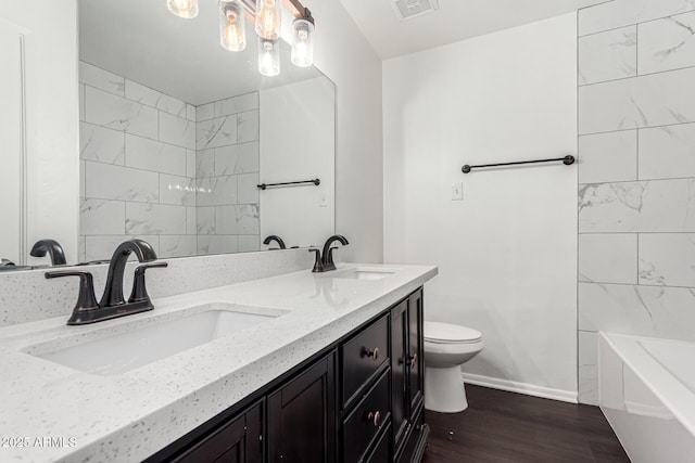 3046 N 32nd St Unit 328, Phoenix, AZ 85018 - bathroom with visible vents, toilet, wood finished floors, and a sink