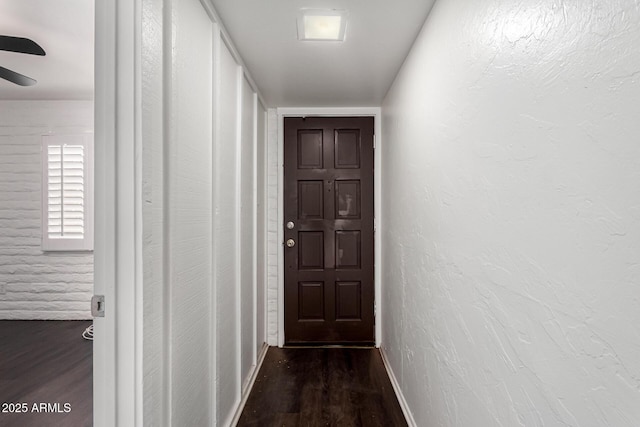 3046 N 32nd St Unit 328, Phoenix, AZ 85018 - corridor with dark wood-type flooring, a textured wall, and baseboards