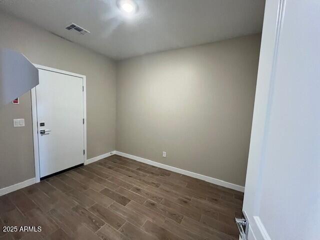 2945 S 232nd Dr, Buckeye, AZ 85326 - spare room with dark wood-style floors and baseboards
