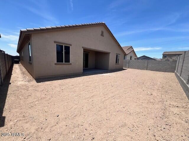 2945 S 232nd Dr, Buckeye, AZ 85326 - rear view of house featuring stucco siding, a fenced backyard, and a patio area