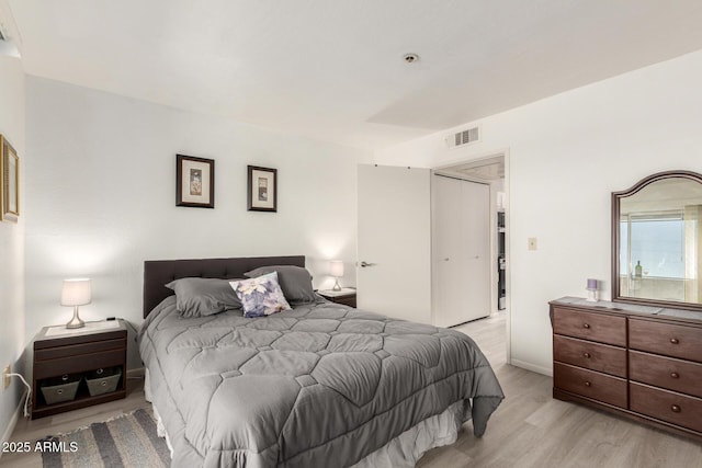 12123 W Bell Rd Unit 339, Surprise, AZ 85378 - bedroom with visible vents, light wood-type flooring, a closet, and baseboards