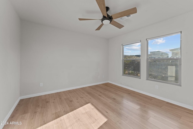 empty room featuring ceiling fan and light wood-type flooring