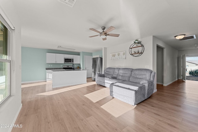 unfurnished living room with light hardwood / wood-style floors and ceiling fan