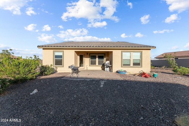 back of property featuring a patio area