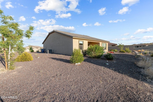 view of side of home with central air condition unit