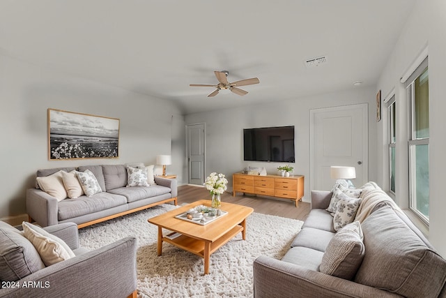 living room featuring ceiling fan and light wood-type flooring