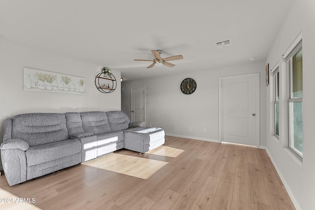 living room featuring ceiling fan and light hardwood / wood-style flooring