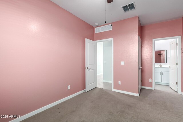 1523 S 223rd Dr, Buckeye, AZ 85326 - unfurnished bedroom featuring a sink, carpet flooring, baseboards, and ensuite bath