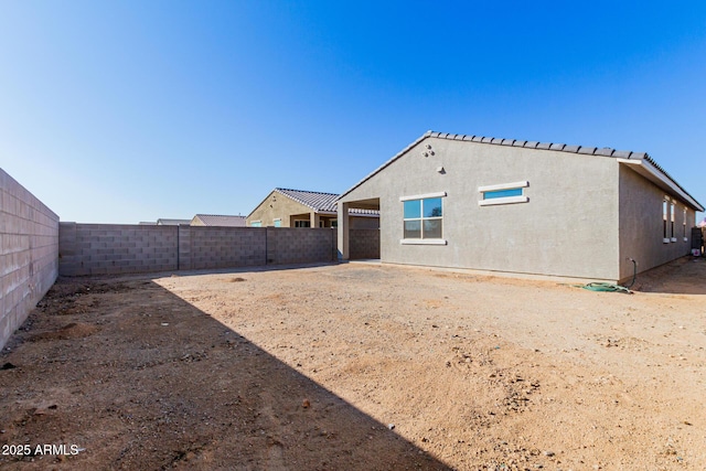 1523 S 223rd Dr, Buckeye, AZ 85326 - rear view of property with a fenced backyard and stucco siding