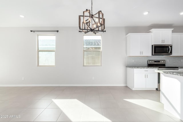 1523 S 223rd Dr, Buckeye, AZ 85326 - kitchen with appliances with stainless steel finishes, healthy amount of natural light, tasteful backsplash, a chandelier, and recessed lighting