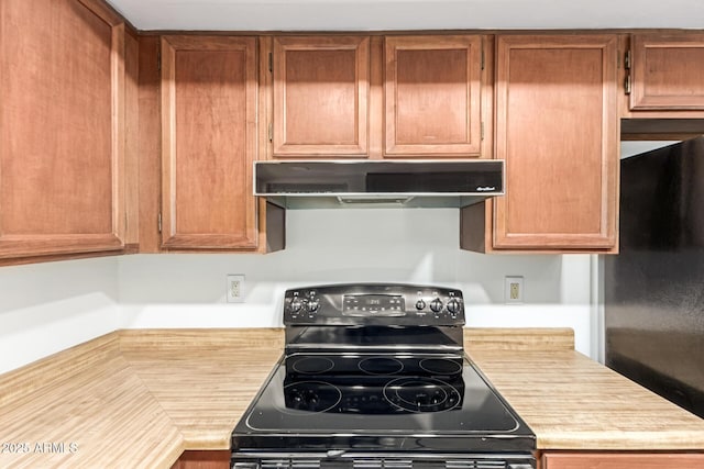 2455 E Broadway Rd Unit 39, Mesa, AZ 85204 - kitchen with light countertops, brown cabinetry, under cabinet range hood, and black appliances