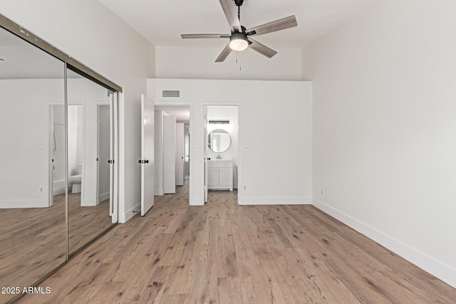 2455 E Broadway Rd Unit 39, Mesa, AZ 85204 - unfurnished bedroom with light wood-type flooring, baseboards, visible vents, a closet, and connected bathroom