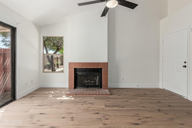 2455 E Broadway Rd Unit 39, Mesa, AZ 85204 - unfurnished living room featuring vaulted ceiling, baseboards, wood finished floors, and plenty of natural light