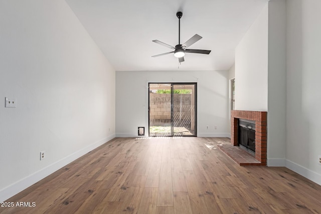 2455 E Broadway Rd Unit 39, Mesa, AZ 85204 - unfurnished living room with baseboards, a ceiling fan, wood finished floors, and a fireplace