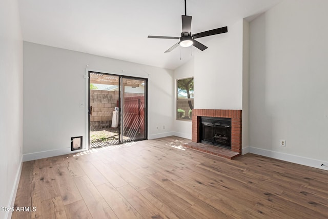 2455 E Broadway Rd Unit 39, Mesa, AZ 85204 - unfurnished living room with vaulted ceiling, a ceiling fan, wood-type flooring, baseboards, and a brick fireplace