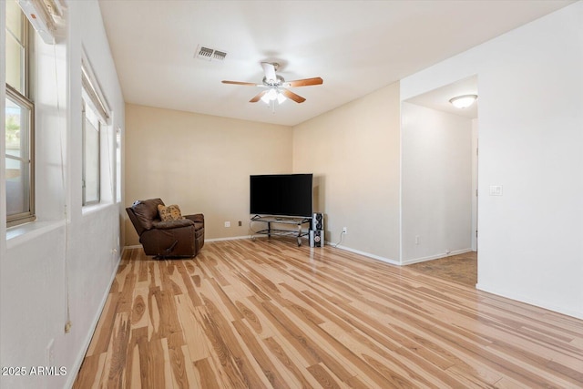 unfurnished room with ceiling fan and light wood-type flooring