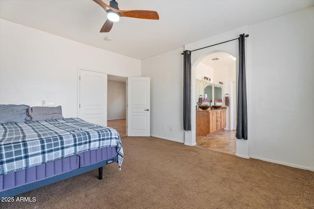 bedroom featuring carpet floors, connected bathroom, and ceiling fan