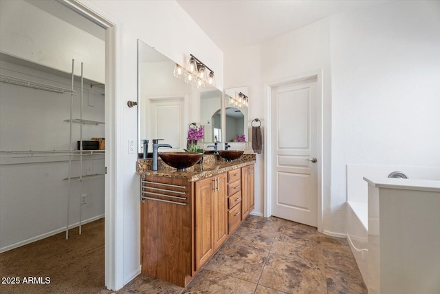 bathroom featuring vanity and a tub