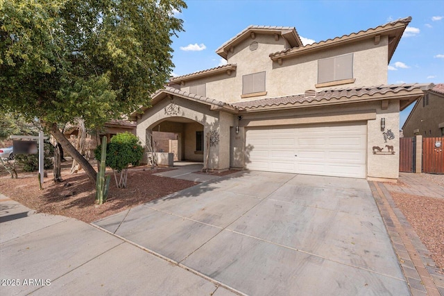 mediterranean / spanish-style house with a garage