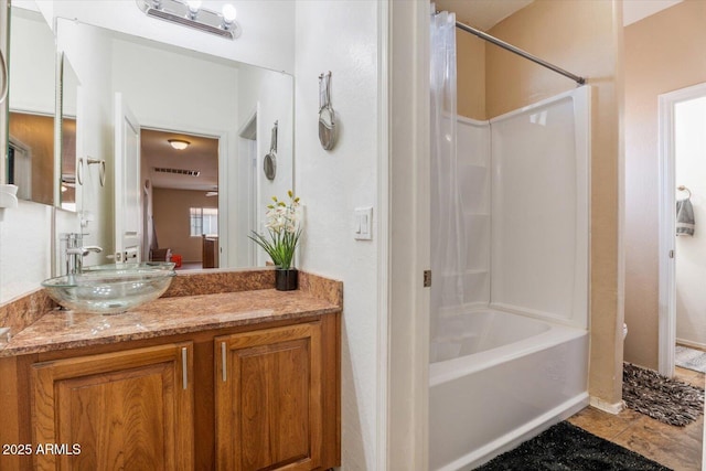 bathroom with tile patterned flooring, vanity, and shower / tub combo