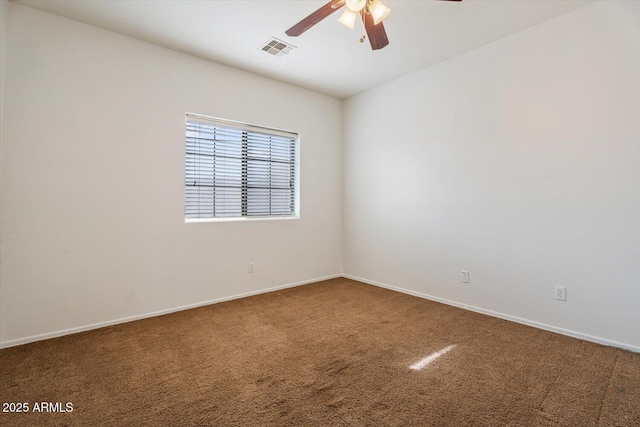 spare room featuring carpet and ceiling fan