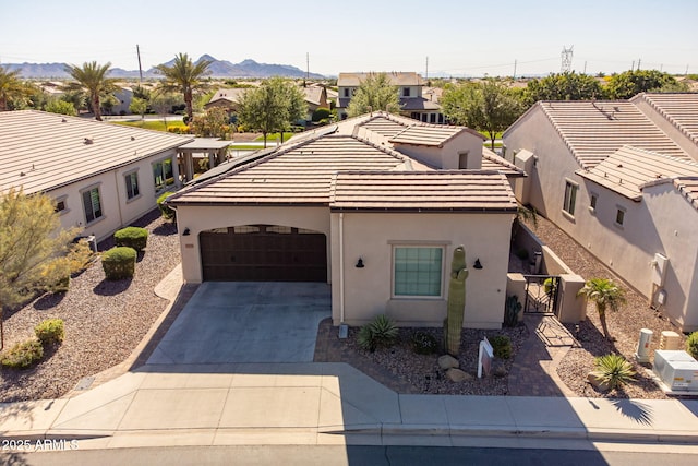 35756 N Clementine Trl, San Tan Valley, AZ 85140 - view of front of home featuring a mountain view, a gate, concrete driveway, an attached garage, and stucco siding