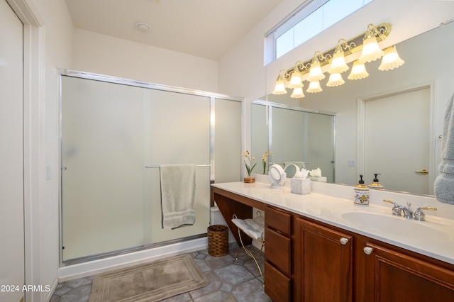 bathroom with tile patterned floors, vanity, and a shower with shower door