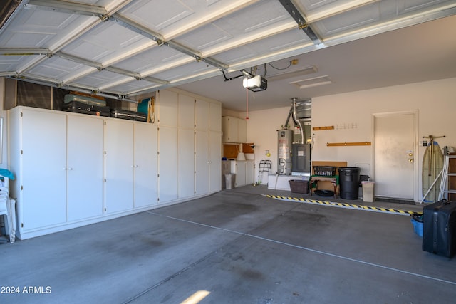 garage with gas water heater and a garage door opener