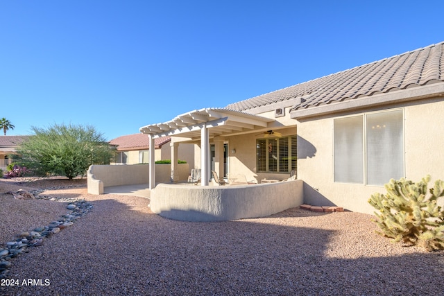 rear view of property featuring a patio and a pergola