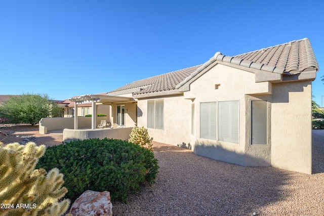 rear view of house with a pergola