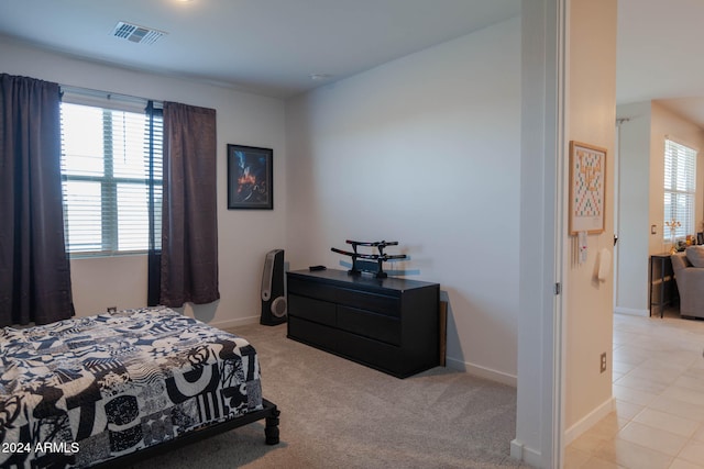 carpeted bedroom with multiple windows