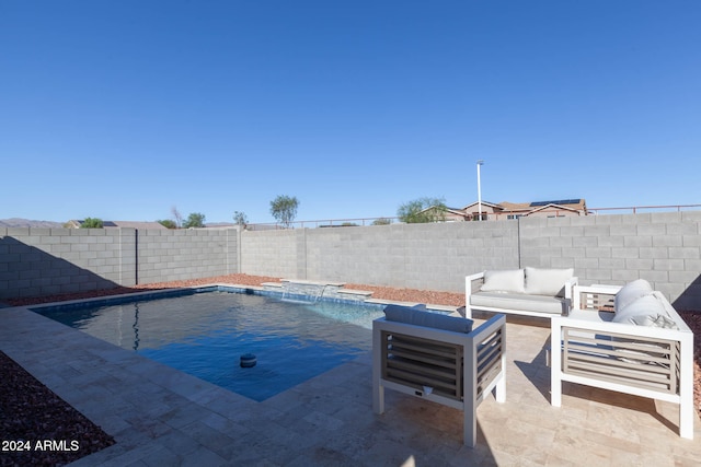 view of pool featuring outdoor lounge area, pool water feature, and a patio area