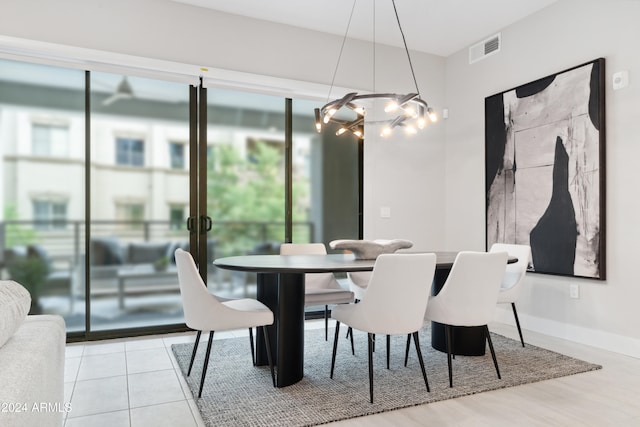 dining area with a chandelier and light hardwood / wood-style floors