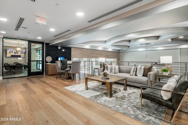 living room featuring light hardwood / wood-style floors and brick wall