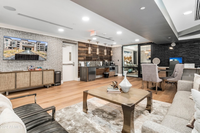 living room featuring light wood-type flooring and sink