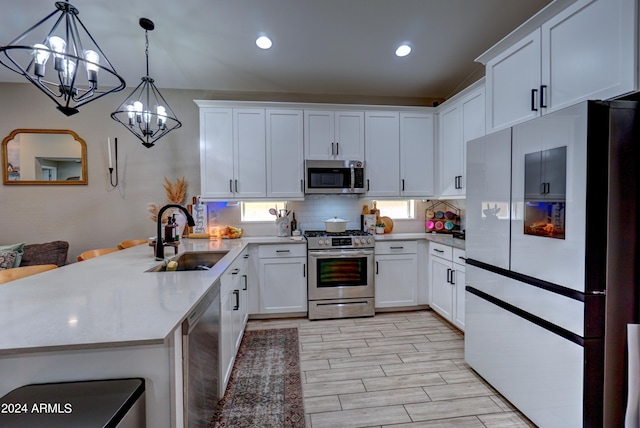 kitchen with sink, white cabinets, and appliances with stainless steel finishes