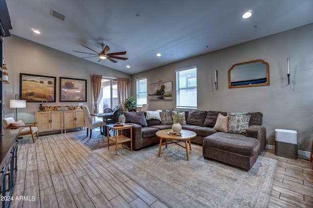 living room featuring ceiling fan and vaulted ceiling